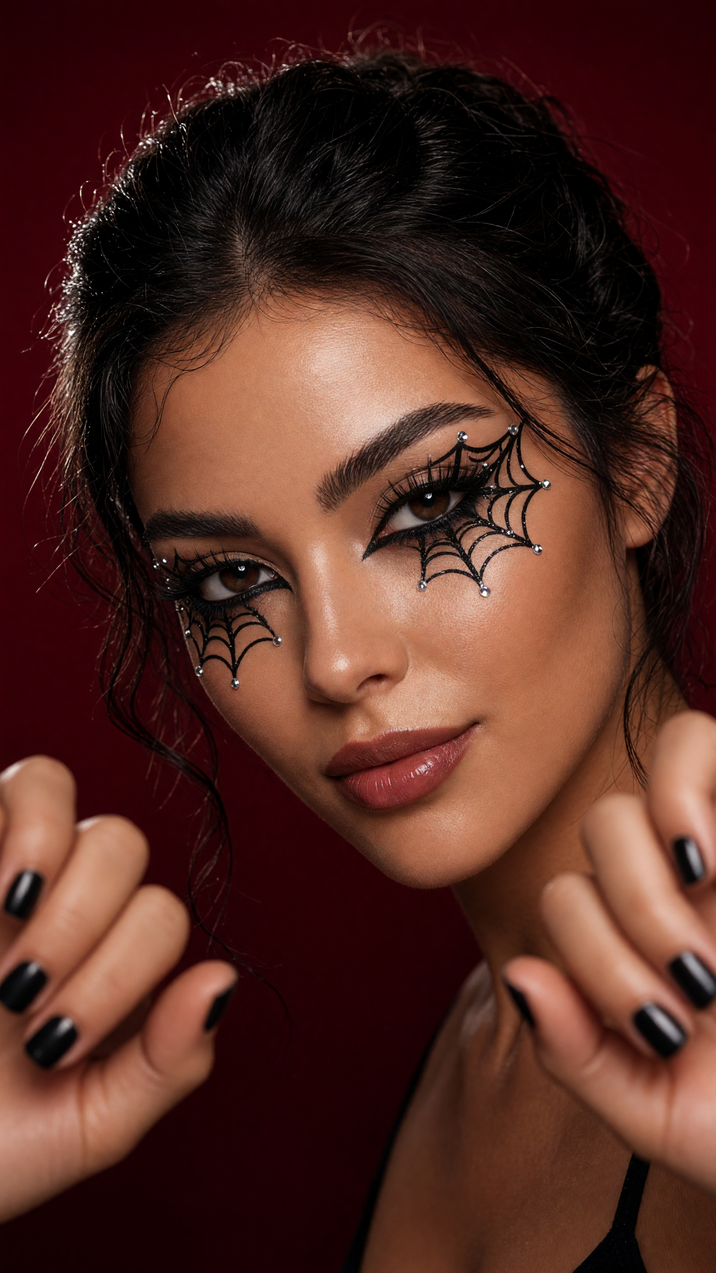Makeup transition with black spiderweb eyeliner and silver gems